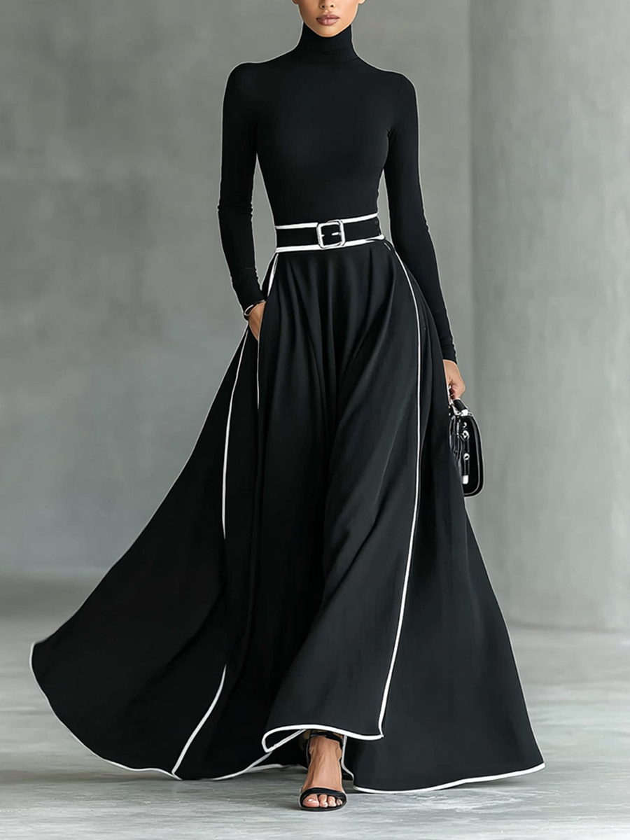 Robe maxi noire avec des coutures blanches, col haut, manches longues et taille cintrée