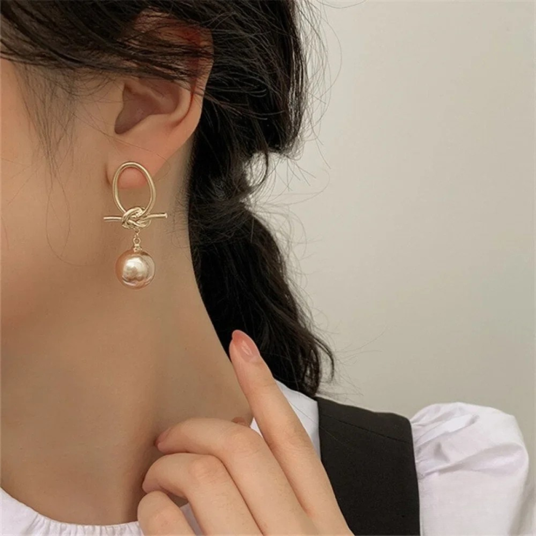 Boucles d'oreilles pendantes avec perle éternelle